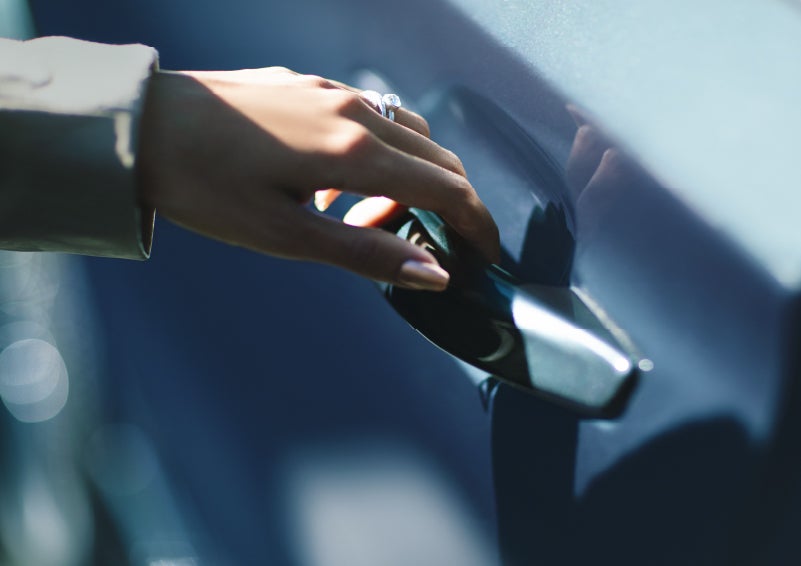 A hand gracefully grips the Light Touch Handle of a 2024 Lincoln Aviator® SUV to demonstrate its ease of use | Bozard Lincoln in Saint Augustine FL